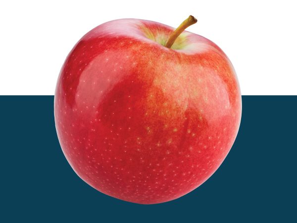 Bright red apple cut out on blue background.