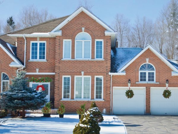 Bev And Co Exterior Of A Brick Home In The Snow Decorated For The Holidays