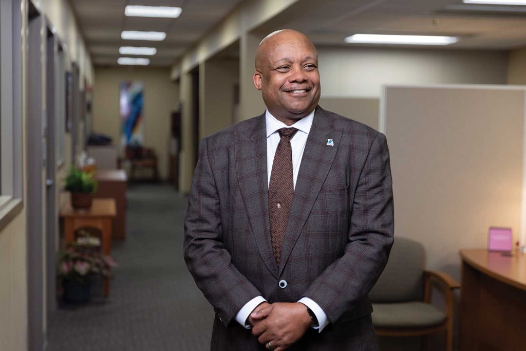 headshot of a man named Brian Yearwood inside of a office building