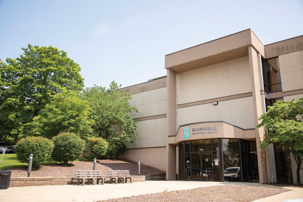 exterior of a large building with a sign that says "Burrell"