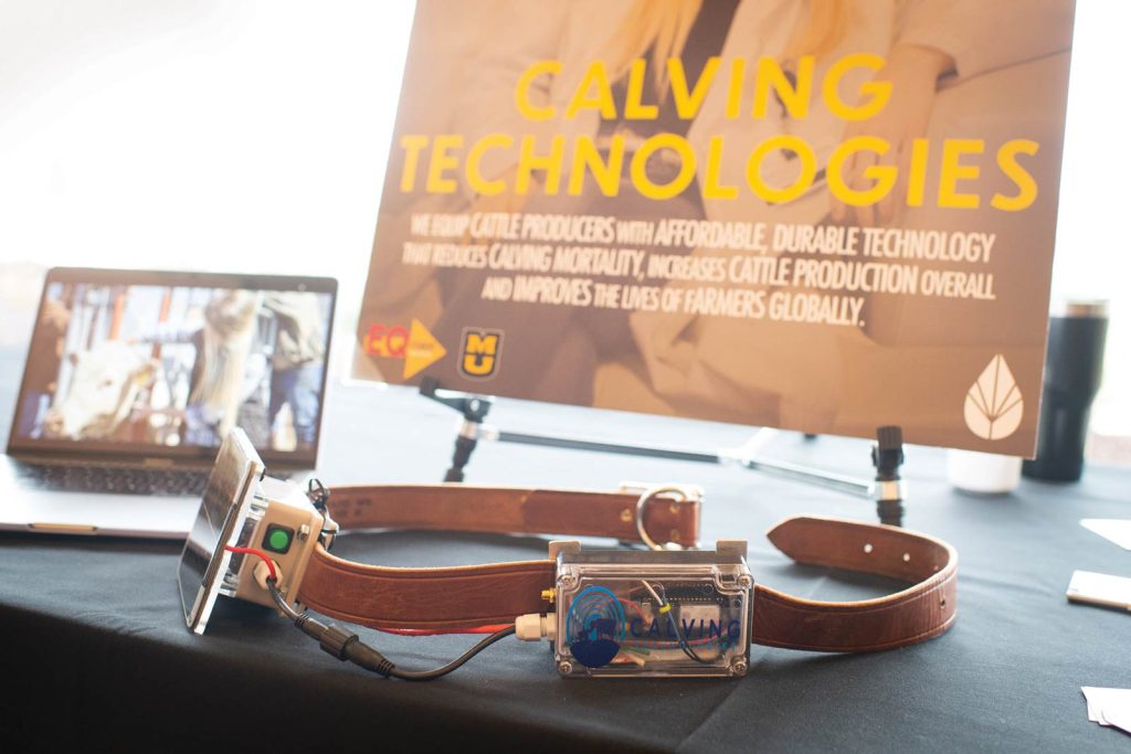 emphasizing solutions for cattle producers. A laptop with a farm-related image is also visible.