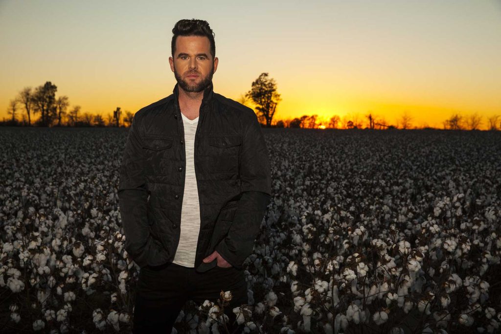 Headshot of David Nail at sunset in a cotton field