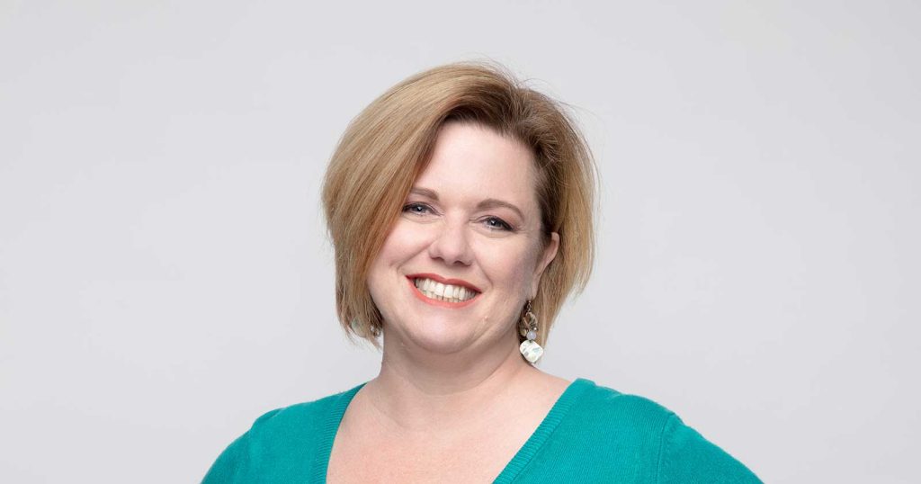 close up headshot of a women named Erica Pefferman against a light grey background