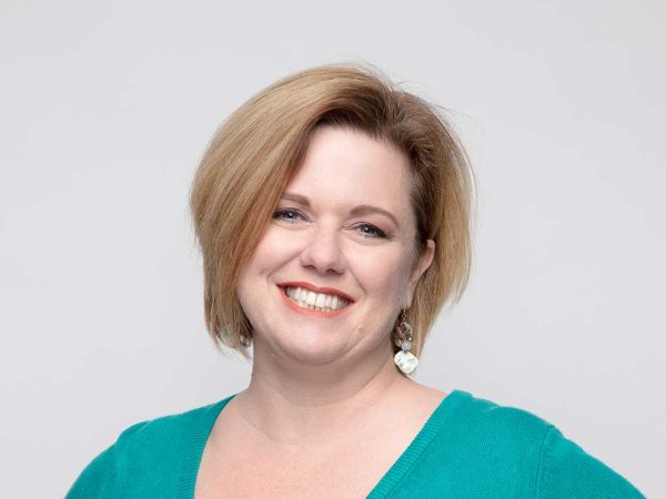 close up headshot of a women named Erica Pefferman against a light grey background