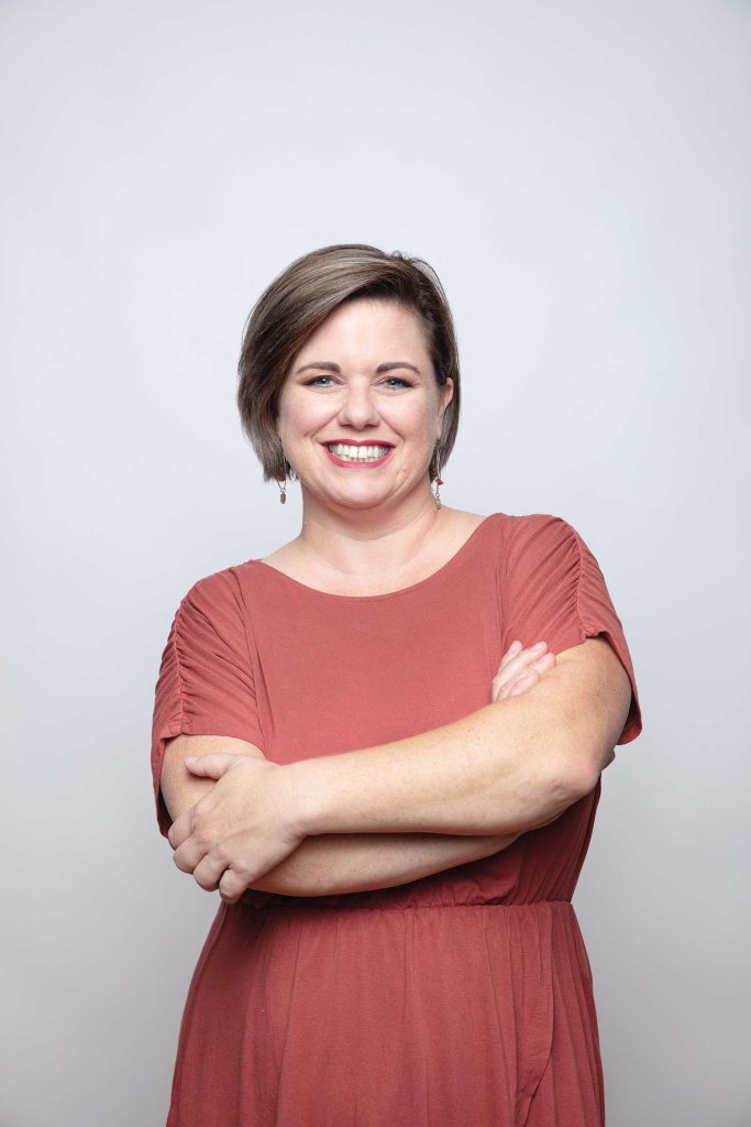 Professional headshot of a women named Erica Pefferman against a light grey background