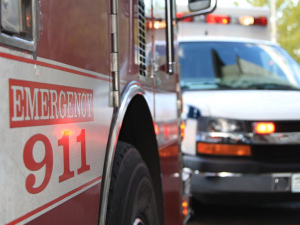 First Responder Gettyimages 147000063 image of the side of a firetruck and ambulance in the distance