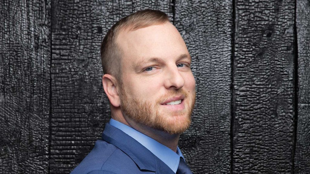 wearing a blue suit and light blue shirt