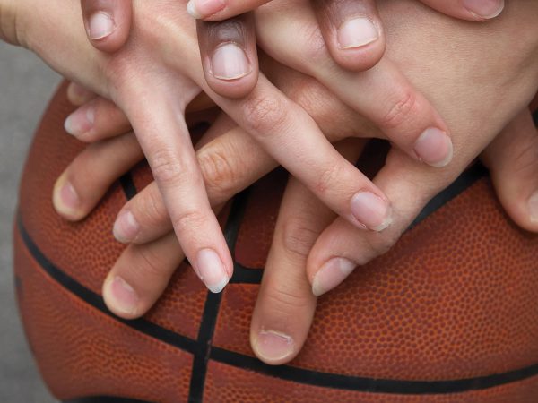 Hands in on a basketball