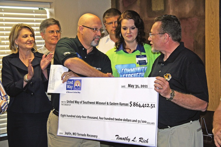 Heart of Missouri United Way Director Tim Rich on June 3 presented a ceremonial donation check to Ron Pence, (left) president of the United Way serving Joplin. Photo by Chris Roberts, Joplin Tri-State Business Journal Heart of Missouri United Way Director Tim Rich on June 3 presented a ceremonial donation check to Ron Pence, (left) president of the United Way serving Joplin. Photo by Chris Roberts, Joplin Tri-State Business Journal
