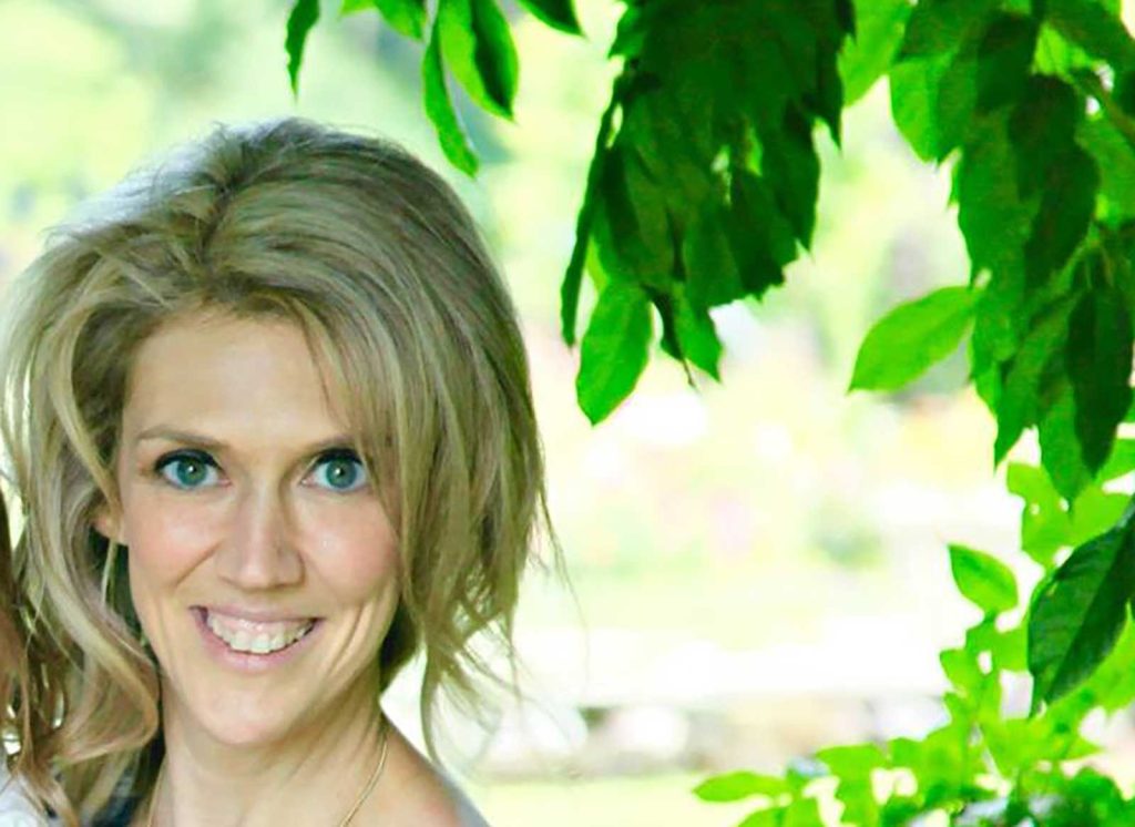 surrounded by lush green foliage. The background is softly blurred