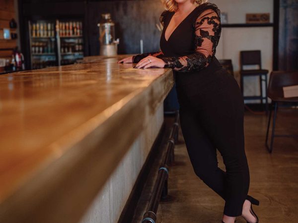 Headshot of a women named Lauren Karr standing by a bartop counter