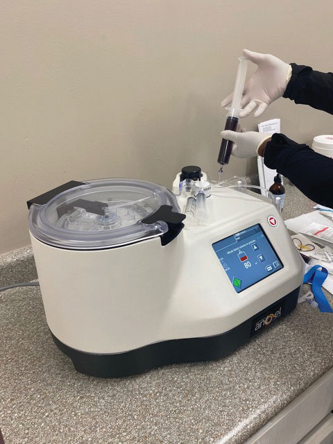 medical centrifuge machine on a countertop. The machine has a digital display