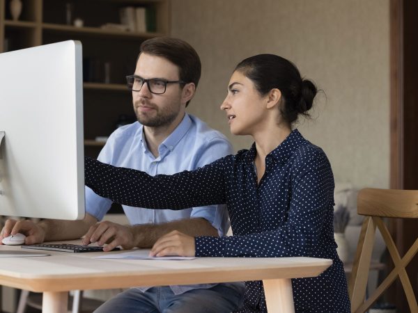 Man and Woman Looking at Computer Screen