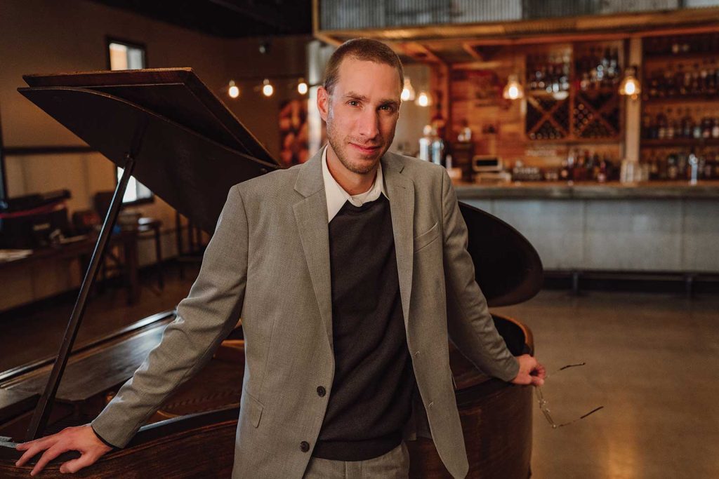 Headshot of a man named Mark Hoehne in front of a piano
