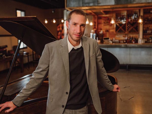 Headshot of a man named Mark Hoehne in front of a piano