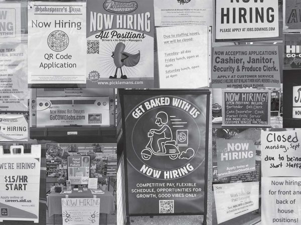 overlapping signs saying "now hiring" from all different places
