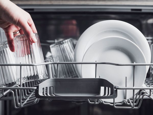 Open Dishwasher With Clean Cutlery Glasses Dishes Inside