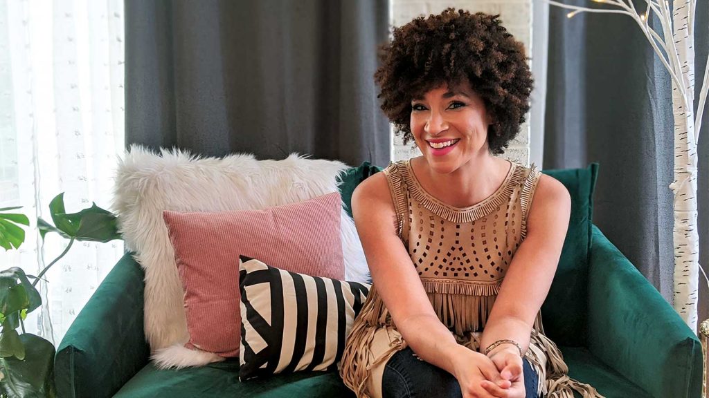 fringed top. The couch has pillows in pink