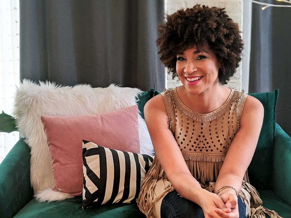 fringed top. The couch has pillows in pink