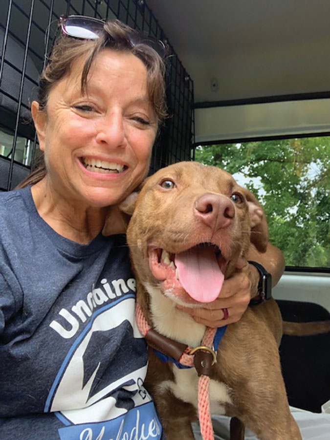 Unchained Melodies Volunteer with a smiling dog