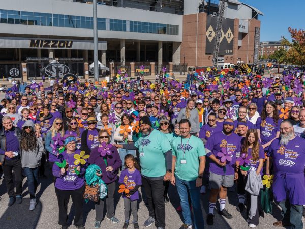 A-Sea-of-faces-wearing-purple-in-front-of-the-MU-arena-preparing-to-walk-to-support-Alzheimers