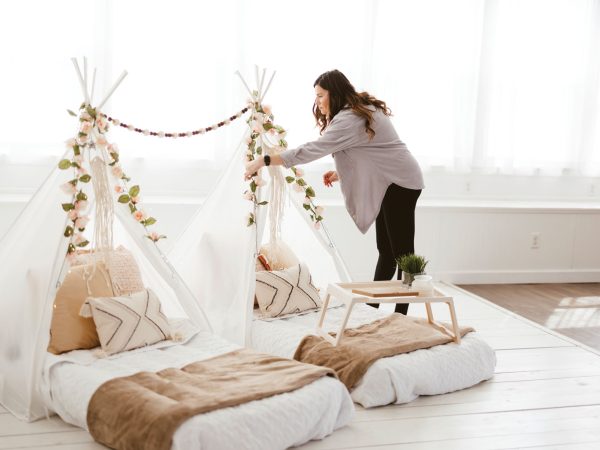white glamping tent|Ashley Minor and Erica Haynes pose between two white