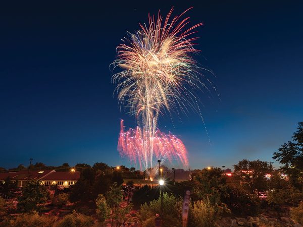 colorful fireworks illuminate the area.|view of a lush flower bed in front of a field where six columns stand in front of a large dome building called "Jesse Hall"|view of a plate of cooked meat served with vegetables|view of a walking trail featuring a wood and metal bridge surrounded by thick forest|view of a large tree on the side of a road surrounded by a field at dusk|close up shot of a platter of six fresh tacos served with lime wedges and a cup of sauce from Carlitos tacos|view of a gold course with a speckling of trees dotting the pristine landscape and a group of golfers standing in the distance|Fisheye lens view of a packed crowd of people at Faurot football field at sunset with a vibrant pink