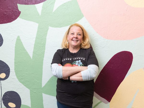 founder and owner of Main Squeeze in Columbia Missouri|Stocked shelves filled with product at Main Squeeze storefront|Leigh Lockhart behind the bakery counter at Main Squeeze|Close up of bakery item and smoothie offered at Main Squeeze|A close up of products in the fridge at Main Squeeze|Interior of Main Squeeze stocked storefront filled with goods|exterior view of Main Squeeze storefront|view of stocked shelves with pantry items at the Main Squeeze|view of decorated shelves with plant propagation jars