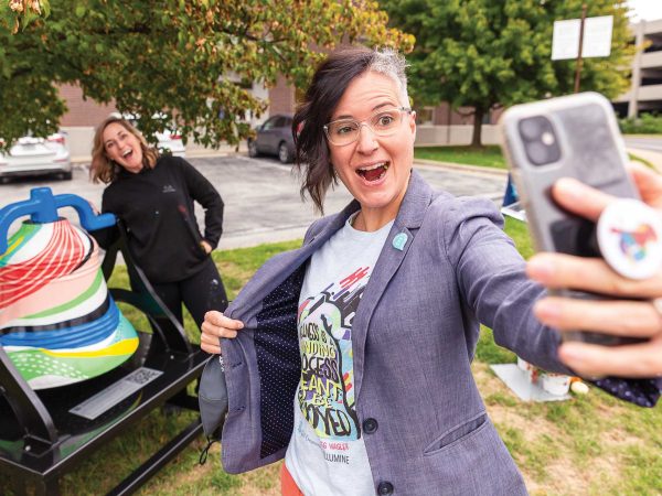 Shelly-Farnen-takes-a-selfie-with-the-bell-and-Meg-Wagler-behind-her