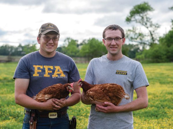 Stanton-Brothers-Farms-Dustin-and-Austin-holding-chickens-ft
