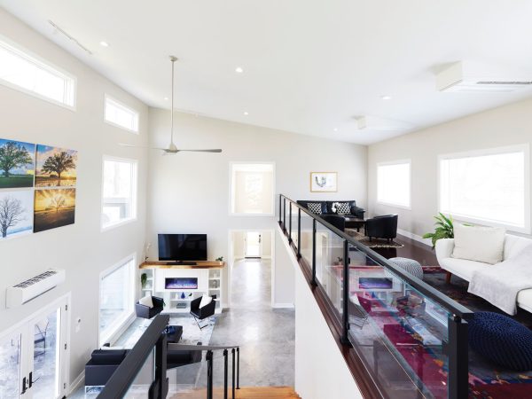 Straight-view-of-the-loft-sitting-area-from-the-top-of-the-stairs-the-lower-levels-fireplace-is-visible