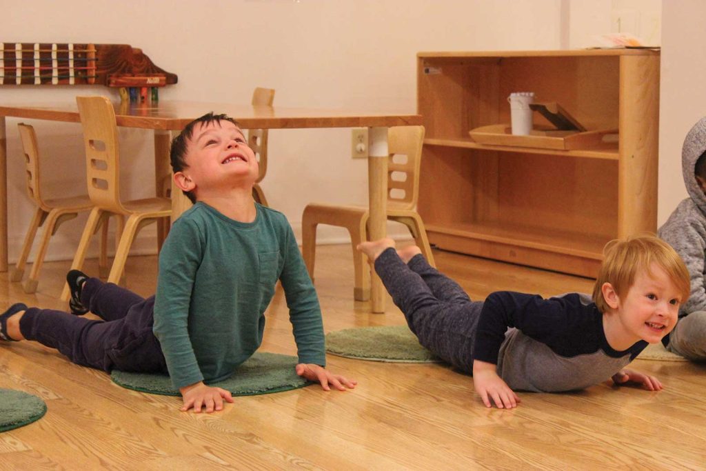 smiling. The child on the left wears a green shirt