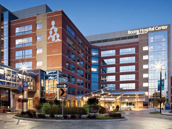 multi-story hospital building with large glass windows