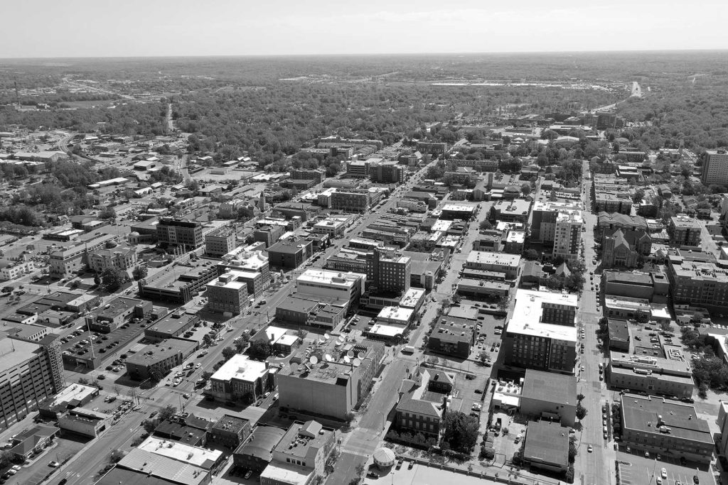 Missouri|black and white professional headshot of a man named Geoff Karr|exterior of a retro painted style building with a sign with the text "Erines"|black and white professional headshot of a women named Lara Piper|exterior of a brick building with a sign that says "Gunter Hans"|exterior of a brick building with a sign that says "Broadway Brewery"|black and white professional headshot of a man named Jesse Walters holding a coffee cup|exterior of a building downtown with a sign that reads "top ten wines"|black and white professional headshot of a man named Nathan Fleischmann