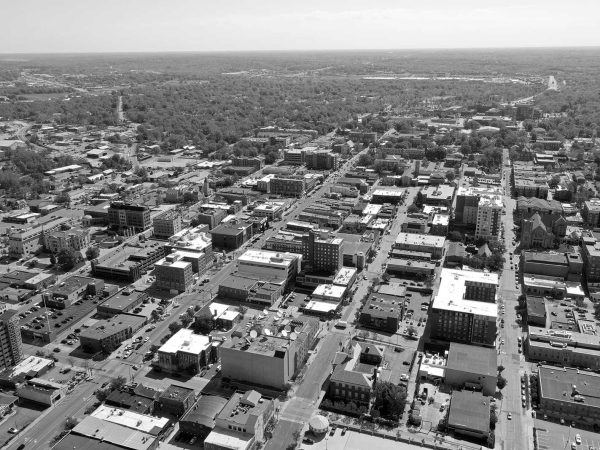 Missouri|black and white professional headshot of a man named Geoff Karr|exterior of a retro painted style building with a sign with the text "Erines"|black and white professional headshot of a women named Lara Piper|exterior of a brick building with a sign that says "Gunter Hans"|exterior of a brick building with a sign that says "Broadway Brewery"|black and white professional headshot of a man named Jesse Walters holding a coffee cup|exterior of a building downtown with a sign that reads "top ten wines"|black and white professional headshot of a man named Nathan Fleischmann