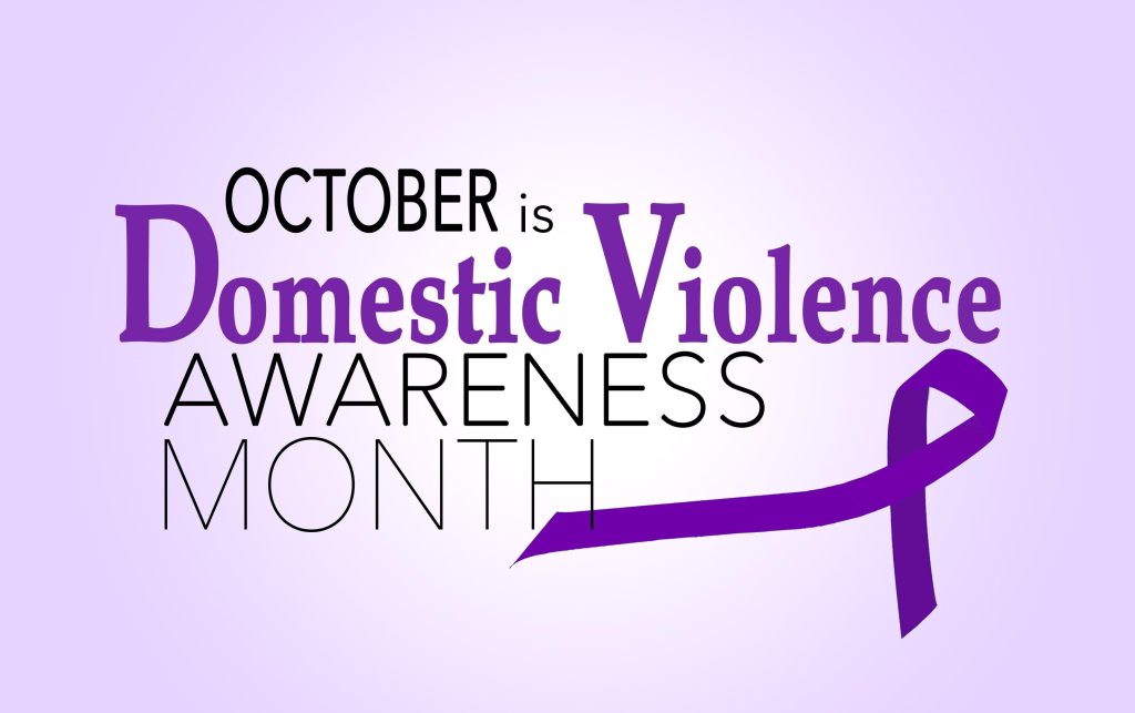 October is Domestic Violence Awareness Month with a purple ribbon symbolizing the cause. Supported by True North of Columbia