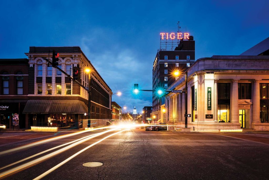 including one with a large TIGER sign on top. The sky is a deep blue