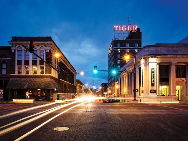 including one with a large TIGER sign on top. The sky is a deep blue