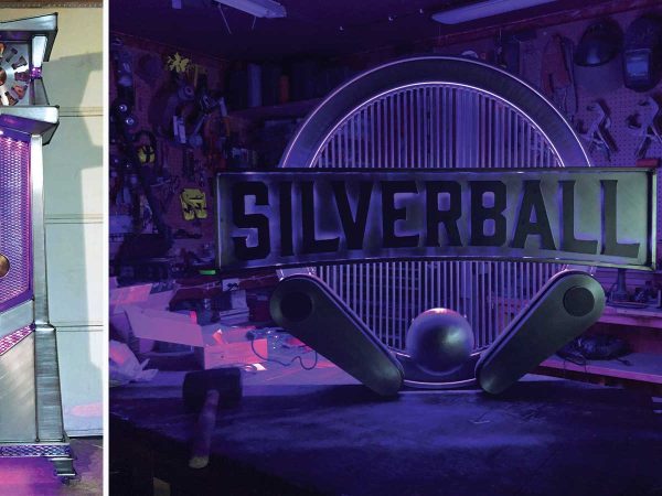 futuristic purple and silver structure with a circular element and geometric patterns. Right: A decorative sign featuring the word Silverball in bold letters