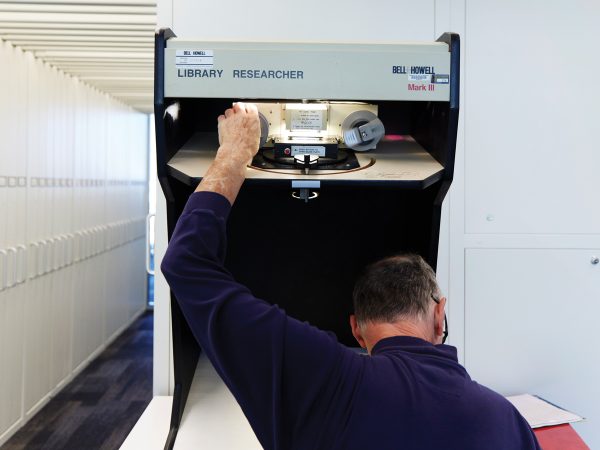 featured-a-researcher-using-a-microfilm-machine