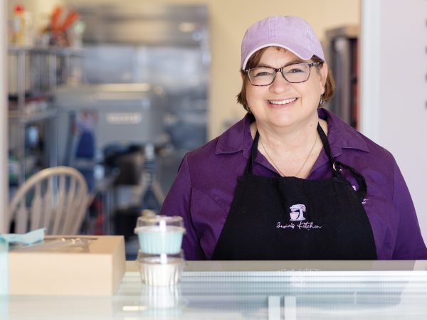 featured-owner-of-jowins-jean-nicklas-poses-behind-counter