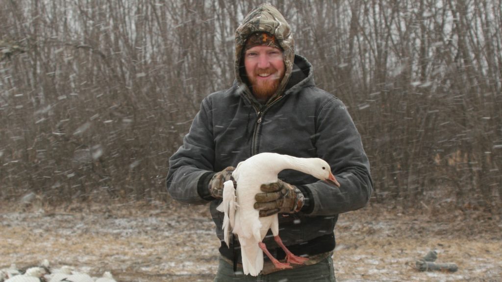 Featured Wildlife Biologist Craig Williamson Holding A Bird