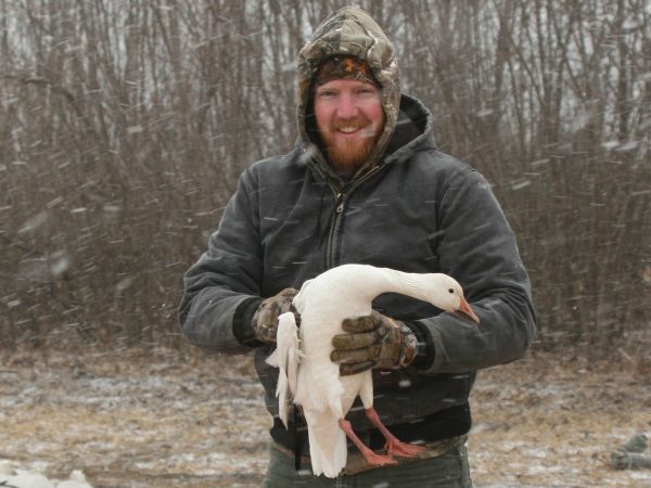 Featured Wildlife Biologist Craig Williamson Holding A Bird