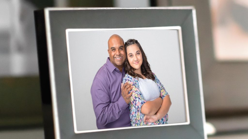 standing in front of a neutral background. They both appear happy.|A man and a woman strike playful poses