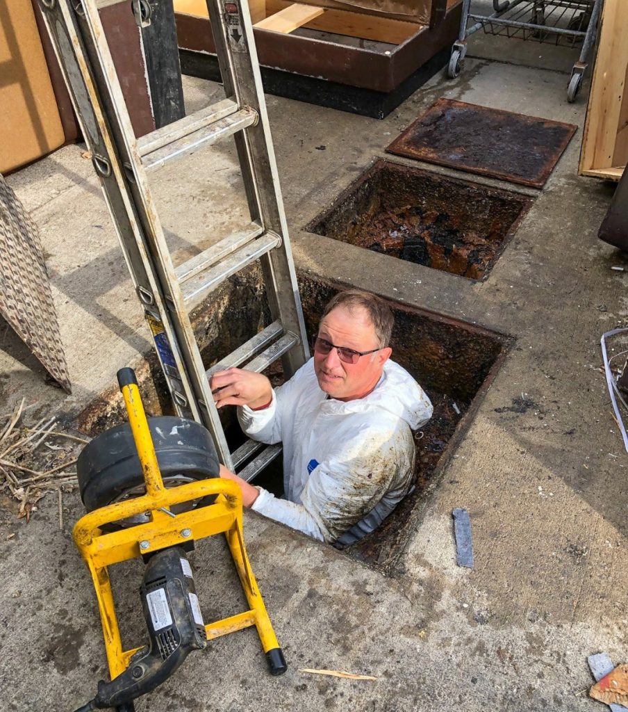 John Martin Of Pro Pumping Hydrojetting Going Down Into A Septic System 
