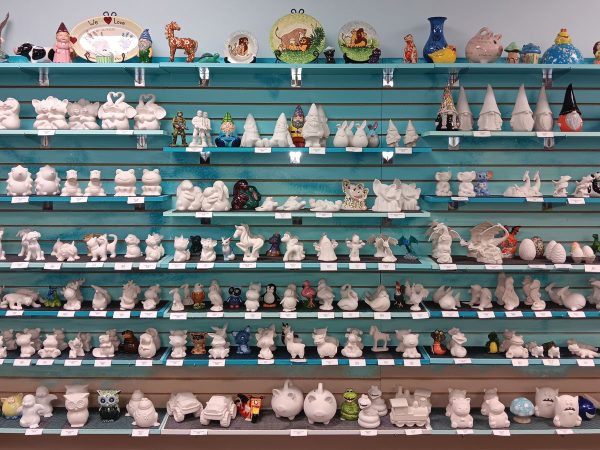 large-wall-of-shelves-filled-with-unpainted-pottery-sculptures
