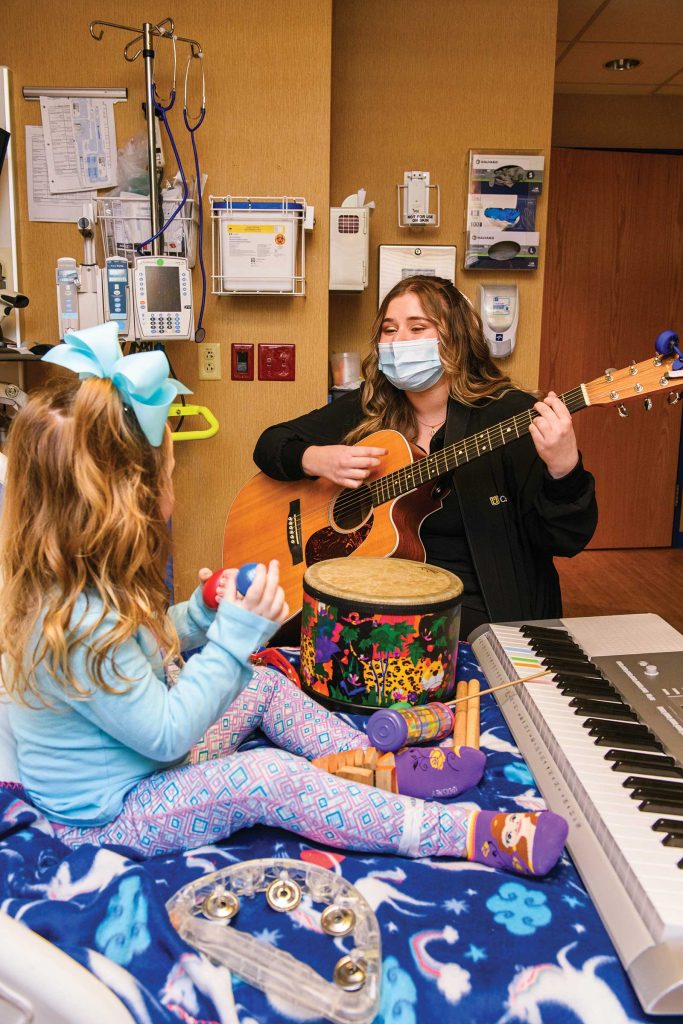 playing percussion instruments. An adult