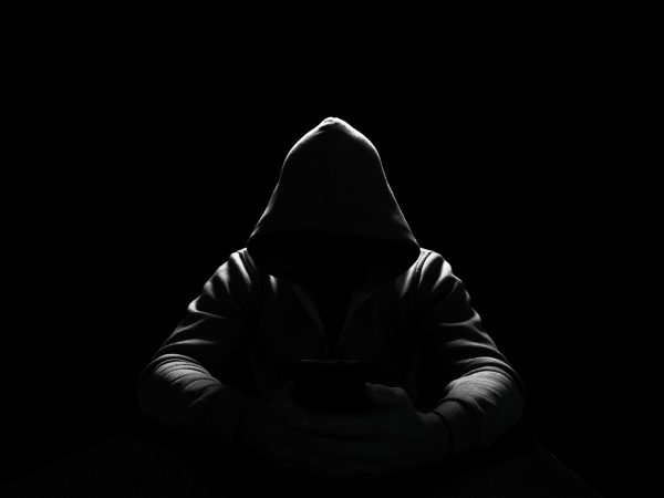 sextortion-dark-hooded-figure