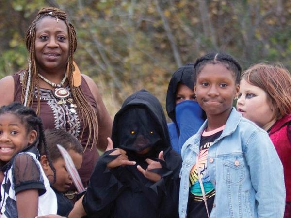 including a hooded figure and a girl in a denim jacket