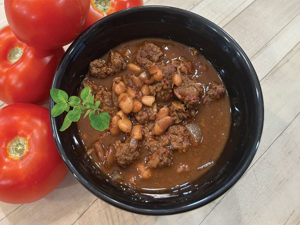 spicy-texas-chili-with-oregano-sprig-and-tomatos